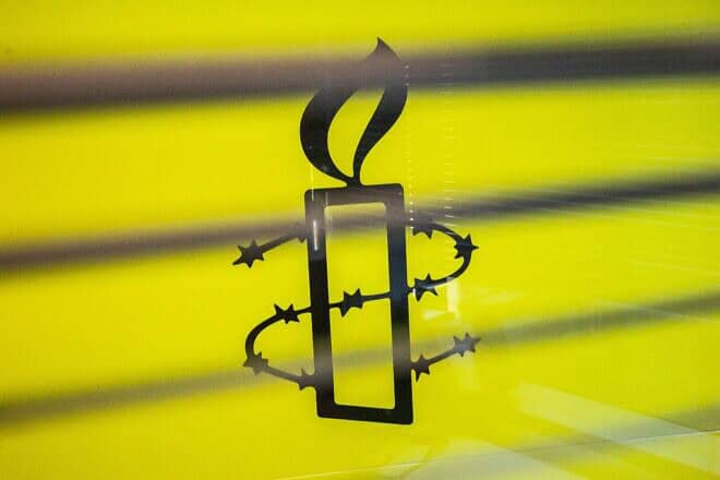 The Amnesty International logo is seen in their offices in Hong Kong, October 2021. Photo by Isaac Lawrence/AFP via Getty Images.