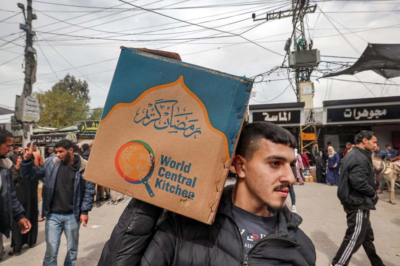 A man carries aid provided by World Central Kitchen in southern Gaza's Rafah area, March 17, 2024. Photo by Mohammed Abed/AFP via Getty Images.