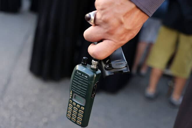 A man holds an Icom walkie talkie device after he removed the battery during the funeral of persons killed when hundreds of paging devices exploded in a deadly wave across Lebanon the previous day, in Beirut's southern suburbs on Sept. 18, 2024. Photo by Anwar Amro/AFP via Getty Images.