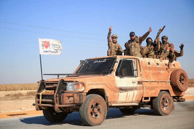 Syrian rebels in a military vehicle in the eastern part of Aleppo Province on Dec. 1, 2024. Photo by Aref Tammawi/AFP via Getty Images.