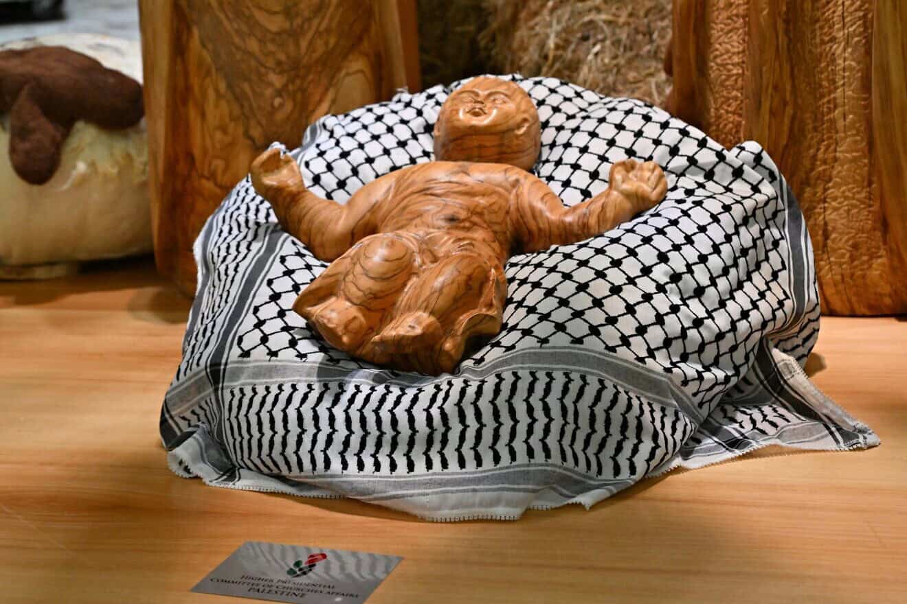 Baby Jesus displayed on a keffiyeh, gifted by the Palestinian Higher Committee of Churches Affairs, as part of the “Nativity of Bethlehem 2024” during its inauguration in the Paul VI Hall, during a private audience to donors of the Nativity Scene and the lighting of the Christmas tree ceremony at St. Peter's Square in the Paul-VI hall at the Vatican on Dec. 7, 2024. Photo by Andreas Solaro/AFP via Getty Images.