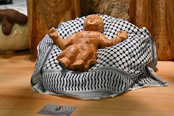 Baby Jesus displayed on a keffiyeh, gifted by the Palestinian Higher Committee of Churches Affairs, as part of the “Nativity of Bethlehem 2024” during its inauguration in the Paul VI Hall, during a private audience to donors of the Nativity Scene and the lighting of the Christmas tree ceremony at St. Peter's Square in the Paul-VI hall at the Vatican on Dec. 7, 2024. Photo by Andreas Solaro/AFP via Getty Images.