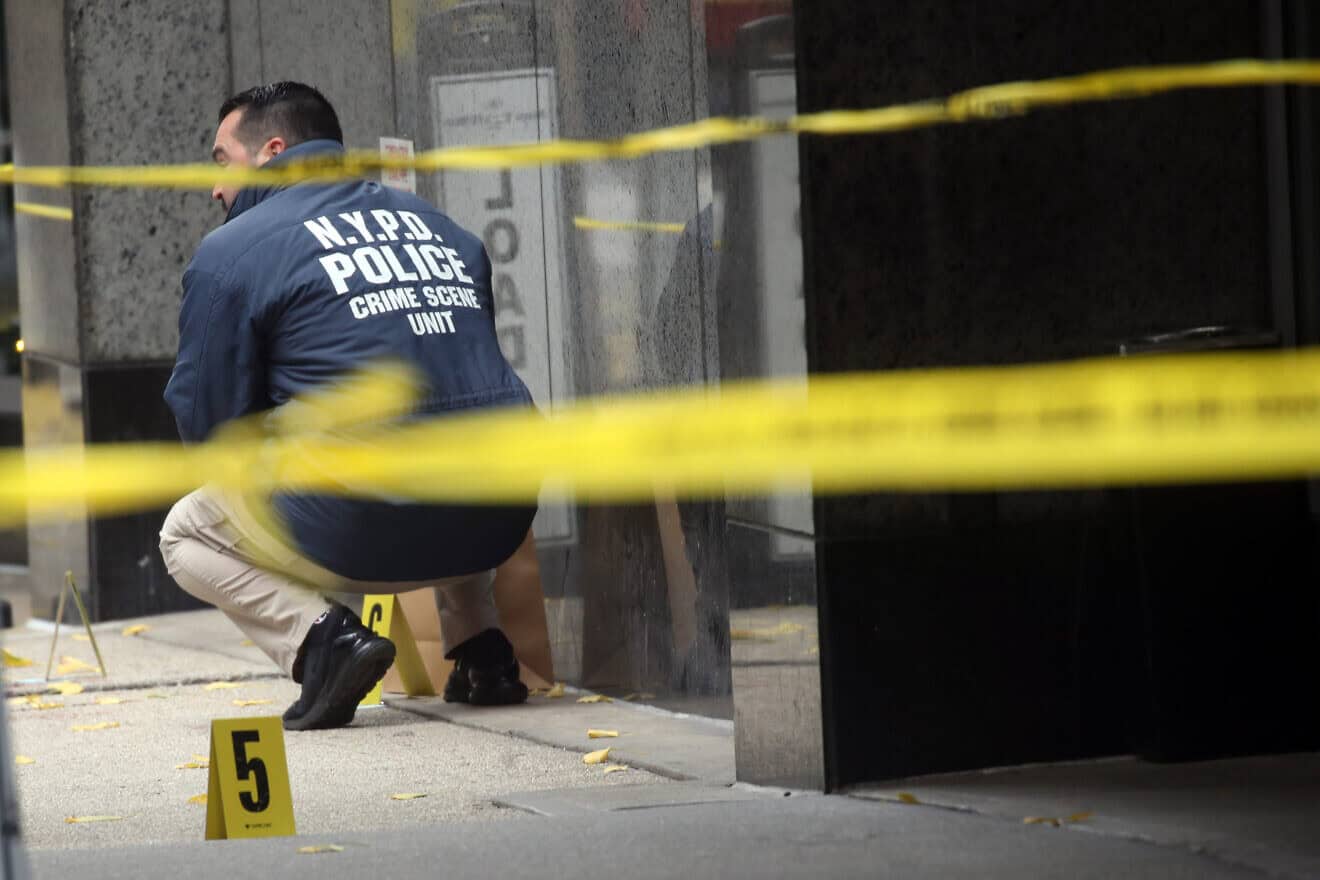 Police place bullet casing markers outside of a Hilton Hotel in Midtown Manhattan where United Healthcare CEO Brian Thompson was fatally shot on Dec. 4, 2024, in New York City. Photo by Spencer Platt/Getty Images.