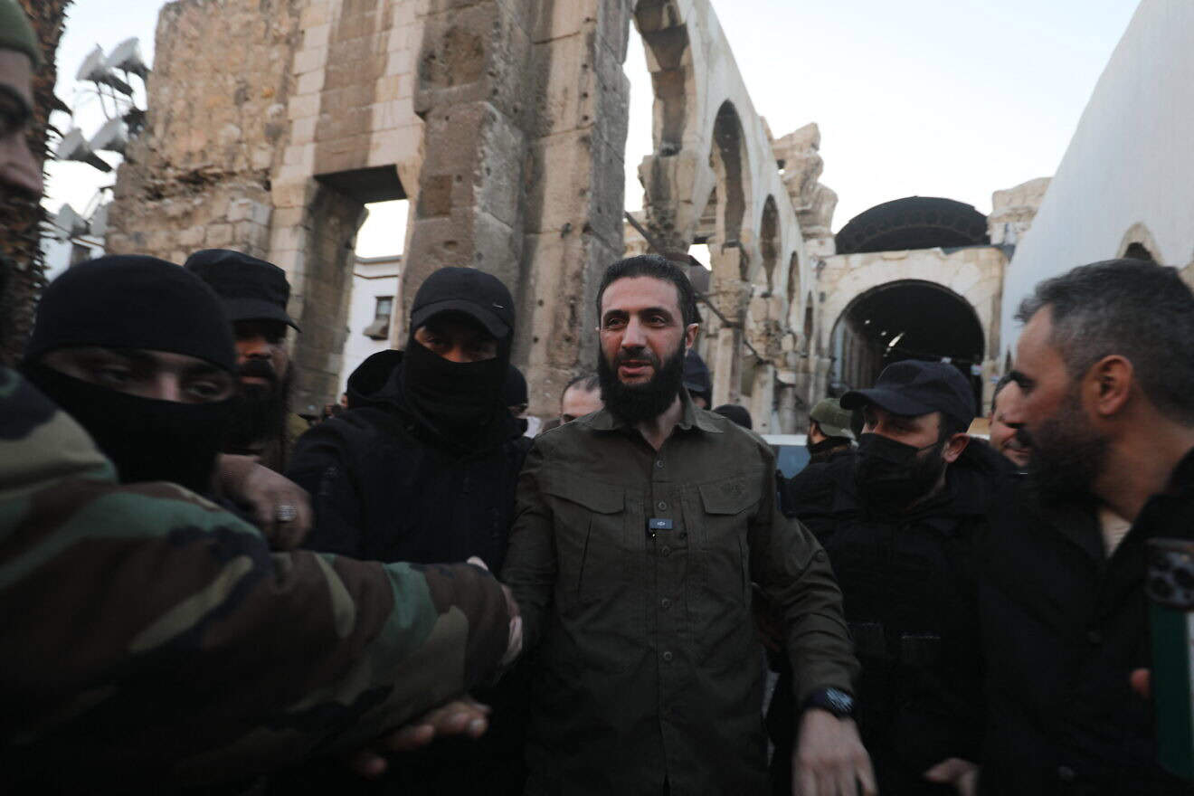 The leader of Syria's Islamist Hayat Tahrir al-Sham (HTS) group that headed a lightning rebel offensive snatching Damascus from government control, Abu Mohammed al-Julani, is welcomed by supporters before addressing a crowd at the capital's landmark Umayyad Mosque on Dec. 8, 2024. Photo by Abdulaziz Ketaz/AFP via Getty Images.
