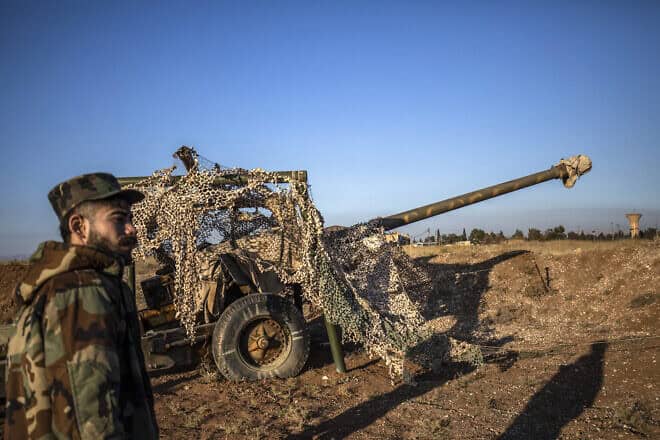 Fighters with the Kurdish-led Syrian Democratic Forces (SDF) inspect damaged and abandoned military vehicles and equipment at the Qamishli international airport, formerly a joint Syrian-russian military base, in northeastern Syria's city of Qamishli on Dec. 9, 2024. Photo by Delil souleiman/AFP via Getty Images.