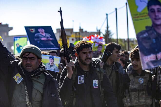 Comrades attend the funeral of five fighters of the Kurdish-led Syrian Democratic Forces (SDF) who were killed in Manbij during clashes with Turkish-backed opposition factions earlier this week, in Qamishli in northeastern Syria on Dec. 14, 2024. Photo by Delil souleiman/AFP via Getty Images.