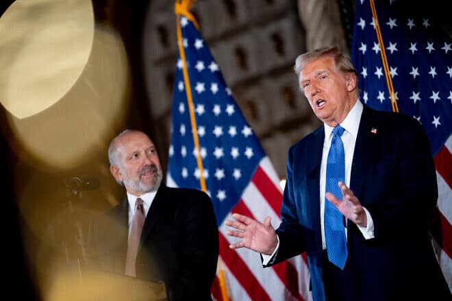 U.S. President-elect Donald Trump, accompanied by his choice for secretary of commerce, Cantor Fitzgerald chairman and CEO Howard Lutnick, speaks at a news conference at the Mar-a-Lago resort on Dec. 16, 2024 in Palm Beach, Fla. Photo by Andrew Harnik/Getty Images.