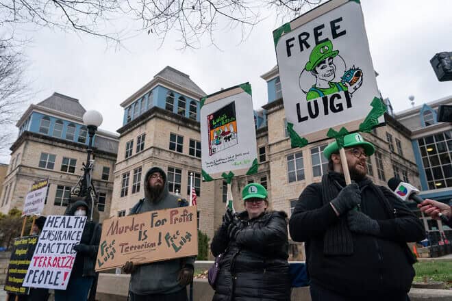 Protesters rally in support of Luigi Mangione, who shot and killed Brian Thompson, CEO of United Healthcare, in New York City on Dec. 4, after he left the Blair County Courthouse in Hollidaysburg, Pa., Dec. 19, 2024. Photo by Adam Gray/AFP via Getty Images.