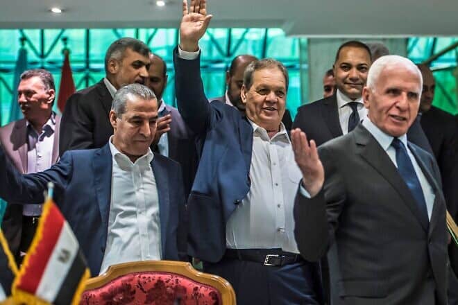 Fatah's Azzam al-Ahmad (R), head of the Fatah delegation for the talks, and Fatah's Rawhi Fattouh (second from right) after signing a reconciliation deal in Cairo on Oct. 12, 2017, as the two rival Palestinian movements ended their decade-long split following negotiations overseen by Egypt. Photo: Khaled Desouki/AFP via Getty Images.