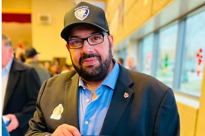 Aaron Hadida, founder of Magen Herut, holds an award that he won for community service, which was presented by Michael Kerzner, solicitor general of Ontario and a member of the provincial Parliament, on Dec. 8, 2024. Photo by Kara Desharnais.