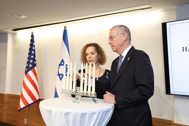 Michael Herzog, Israeli ambassador to the United States, and his wife Shirin Herzog light a candle at a Chanukah party at the Israeli embassy in Washington, Dec. 18, 2024. Credit: Shmulik Almany and Talia Garber/Embassy of Israel.