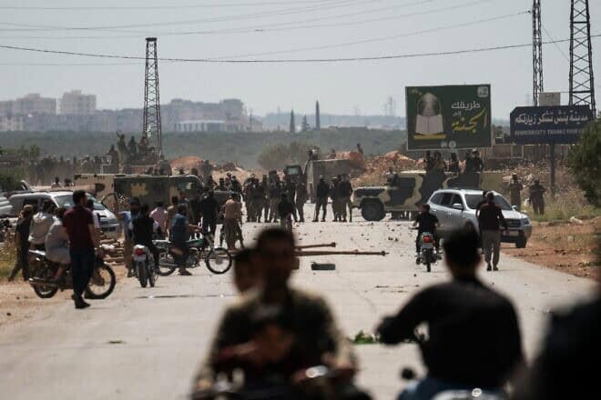 Members of Hayat Tahrir al-Sham shoot bullets and throw tear gas bombs to disperse demonstrators on the way to Idlib governorate to participate in a central demonstration 
 demanding the overthrow of the leader of Hayat Tahrir al-Sham, Abu Muhammad al-Julani, in Binnish, Syria, on May 17, 2024. Al-Julani has since ked the takeover of Syrian cities, including Damascus, leading to the downfall of the Bashar Assad regime. Photo by Moawia Atrash/Middle East Images/AFP via Getty Images.