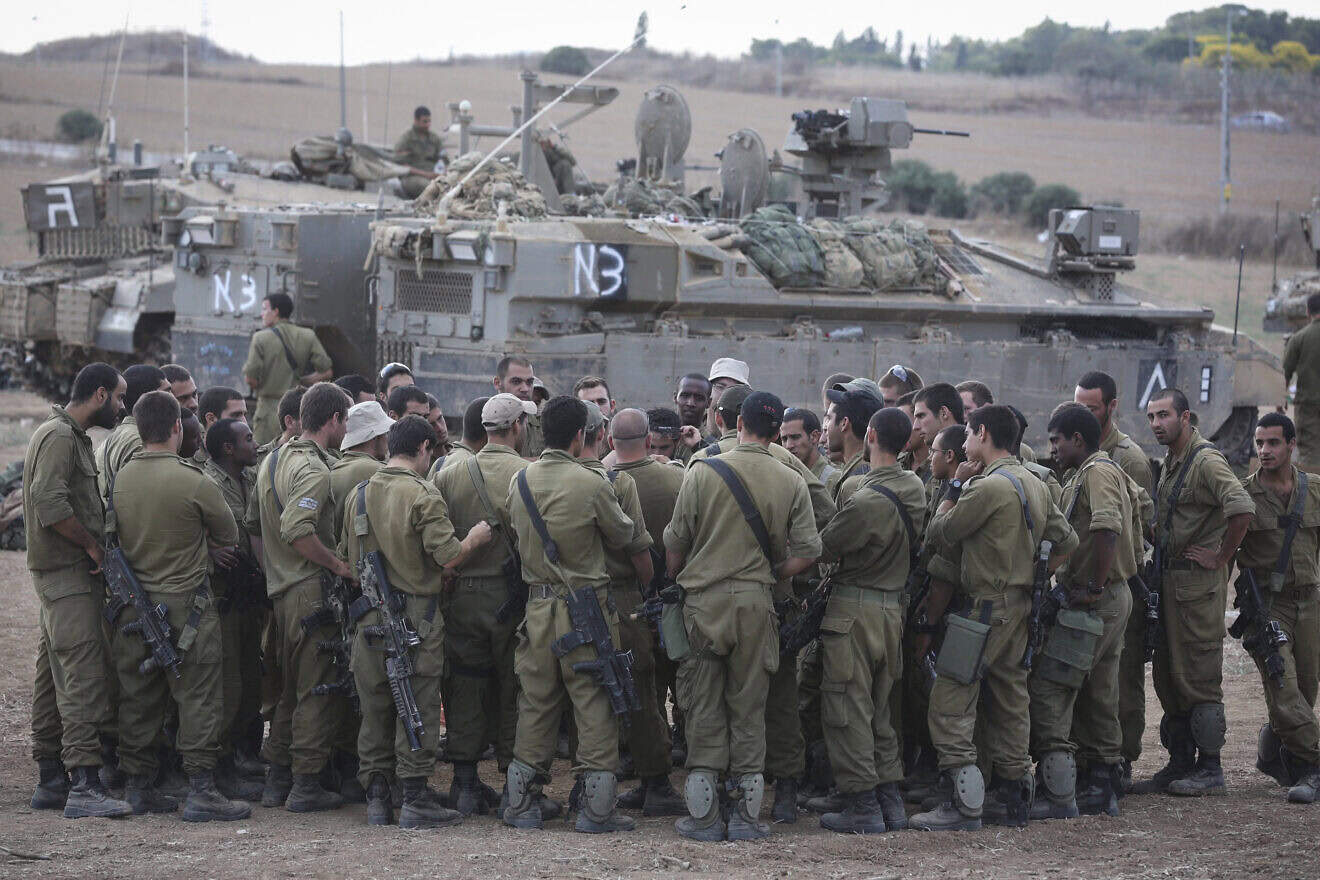 IDF reservists at an assembly point near the border with Gaza during "Operation Protective Edge" against terrorists in the Strip, July 19, 2014. Photo by Nati Shohat/Flash90.