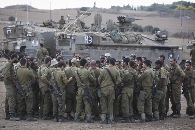 IDF reservists at an assembly point near the border with Gaza during "Operation Protective Edge" against terrorists in the Strip, July 19, 2014. Photo by Nati Shohat/Flash90.