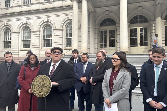 Justin Brannan, a member of the New York City Council, speaks at a press conference outside City Hall in Manhattan before the council voted to pass a bill, which he cosponsored, expanding private school access to city funding for security, Dec. 19, 2024. Photo by Vita Fellig.