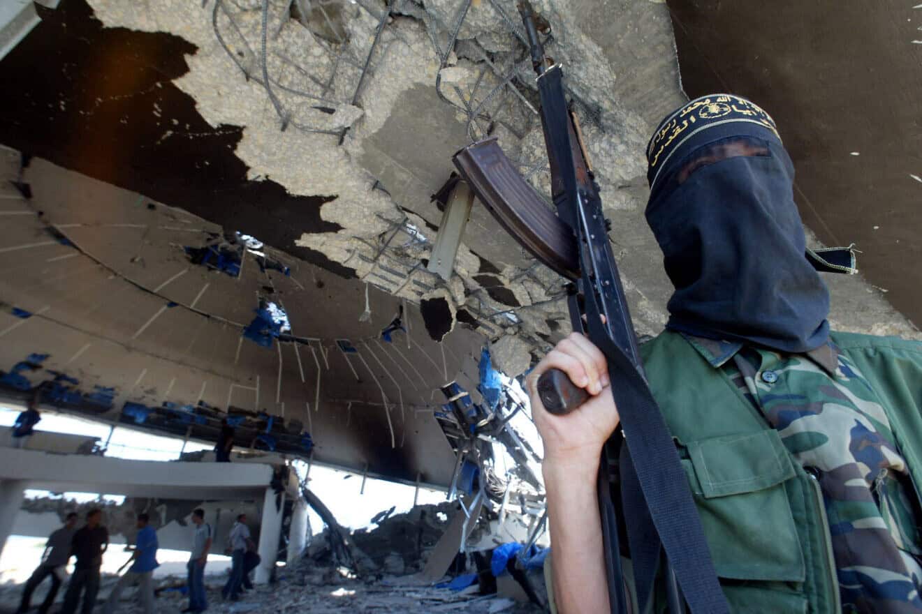 An Islamic Jihad terrorist stands inside the ruins of the Netzarim community synagogue after the disengagement from the Gaza Strip, Sept. 12, 2005. Photo by Ahmad Khateib/Flash90.