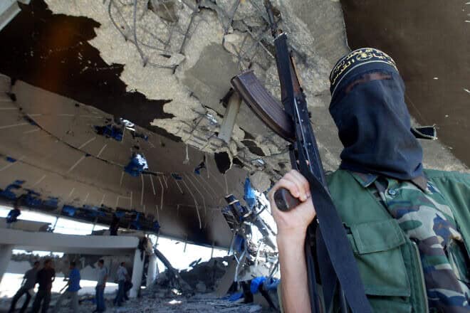 An Islamic Jihad terrorist stands inside the ruins of the Netzarim community synagogue after the disengagement from the Gaza Strip, Sept. 12, 2005. Photo by Ahmad Khateib/Flash90.