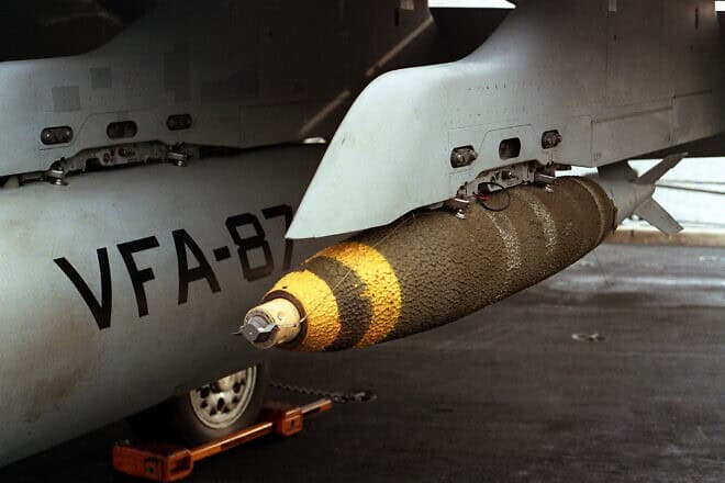 A Mark 82 500-pound general-purpose bomb hangs from a pylon beneath the wing of a Strike Fighter Squadron 87 Hornet aircraft aboard the nuclear-powered aircraft carrier “USS Theodore Roosevelt” during “Operation Desert Storm,” Feb. 13, 1991. Credit: Lt. Parsons/U.S. Defense Industry via Wikimedia Commons.