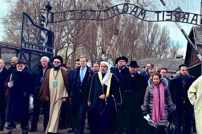 Muhammad al-Issa, secretary general of the Muslim World League (center), leads a delegation of Muslim leaders to the grounds of Auschwitz and its memorial in January 2020. Credit: American Jewish Committee via Wikimedia Commons.