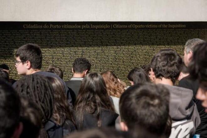 Teens view the wall of names of victims of the Inquisition from Oporto. Photo by CIP/Bizarro.
