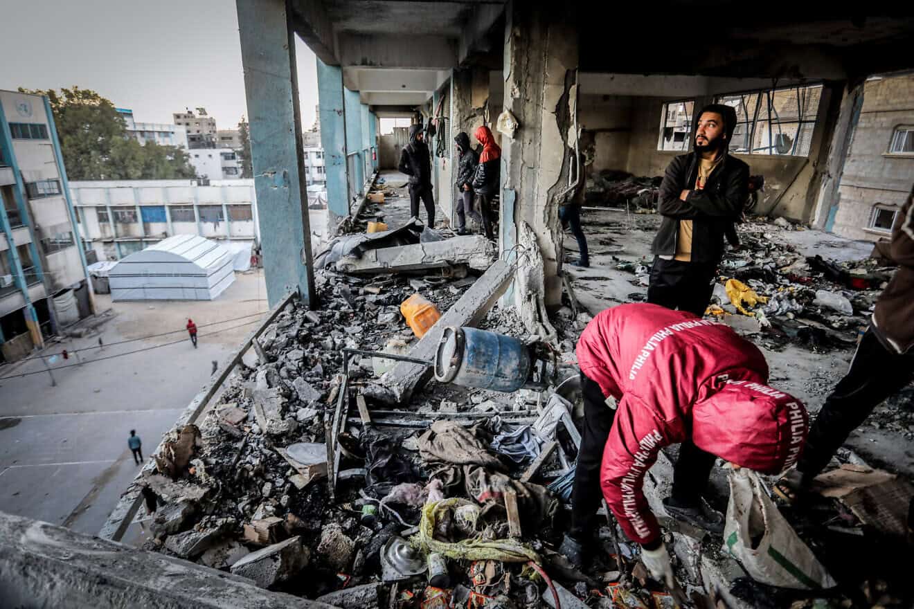 Palestinians return to the UNRWA Ahmed bin Abdul Aziz School, which houses displaced people, after an Israeli airstrike that killed 16 people and injured many others, as the conflict between Israel and Hamas continues in the southern Gaza Strip city of Khan Younis, Dec. 15, 2024. Photo by Abed Rahim Khatib/Flash90.
