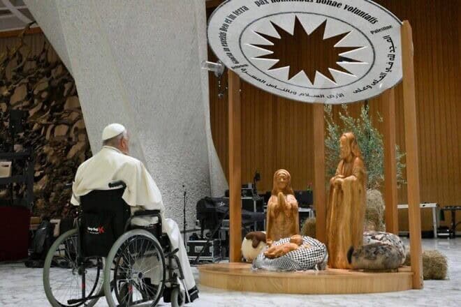 Pope Francis surveys the Nativity scene at the Vatican featuring a baby Jesus displayed on a keffiyeh, gifted by the Palestinian Higher Committee of Churches Affairs, as part of the “Nativity of Bethlehem 2024.” Credit: Vatican Media via Crux.