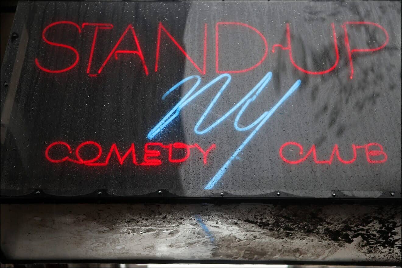 A close-up of the neon sign for the Stand Up NY Comedy Club on Manhattan's Upper West Side, May 8, 2013. Photo by Oliver Morris/Getty Images.