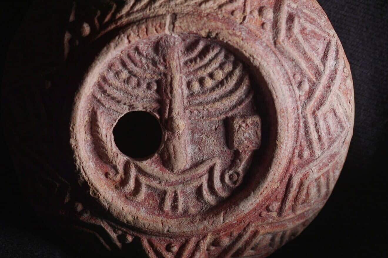 The ancient oil lamp, decorated with a menorah, incense shovel and lulav. Photo by Emil Aladjem/IAA.