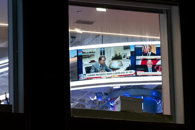 Televisions inside the News Corp. Building in New York City show news reports announcing the death of former President Jimmy Carter on Dec. 29, 2024. The 39th U.S. president died at age 100, making him the longest lived president in American history. Photo by Adam Gray/Getty Images.