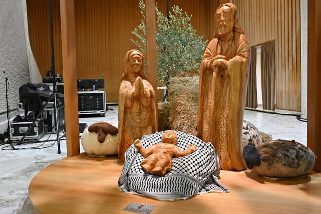 Baby Jesus displayed on a keffiyeh, gifted by the Palestinian Higher Committee of Churches Affairs, as part of the “Nativity of Bethlehem 2024” during its inauguration in the Paul VI Hall, during a private audience to donors of the Nativity Scene and the lighting of the Christmas tree ceremony at St. Peter's Square in the Paul-VI hall at the Vatican on Dec. 7, 2024. Photo by Andreas Solaro/AFP via Getty Images.