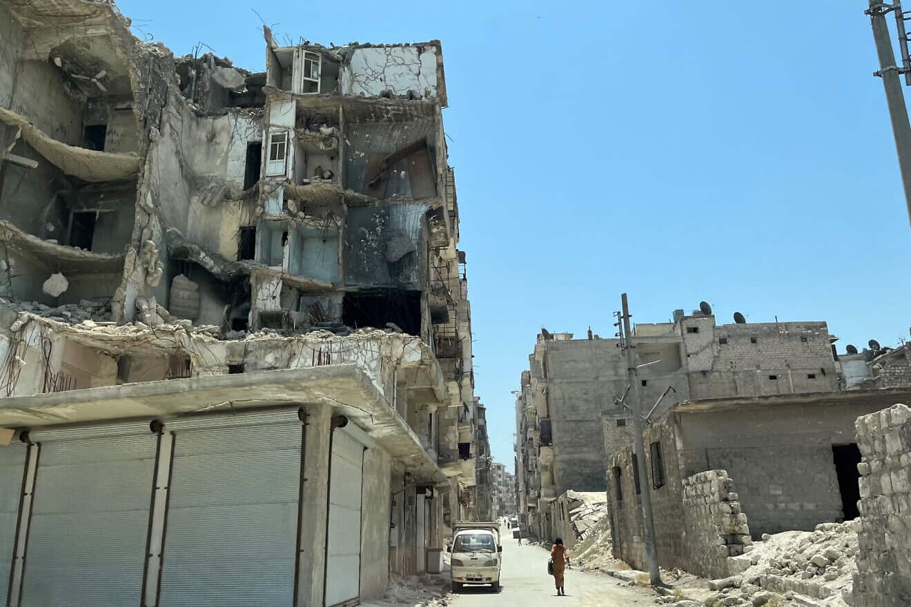 A woman walks down a street in war-torn Aleppo, Syria, on June 1, 2022. Photo by Anouk Delafortrie/European Union/Flickr.