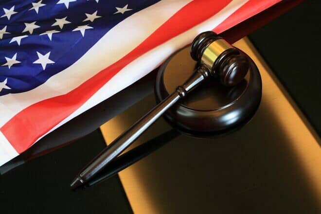 Gavel next to American flag. Credit: Sergei Tokmakov via Pixabay