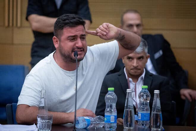 A man cries during an emergency meeting of the lobby for aid to IDF veterans with PTSD and their families at the Knesset in Jerusalem on Aug. 8, 2023. Photo by Oren Ben Hakoon/Flash90.