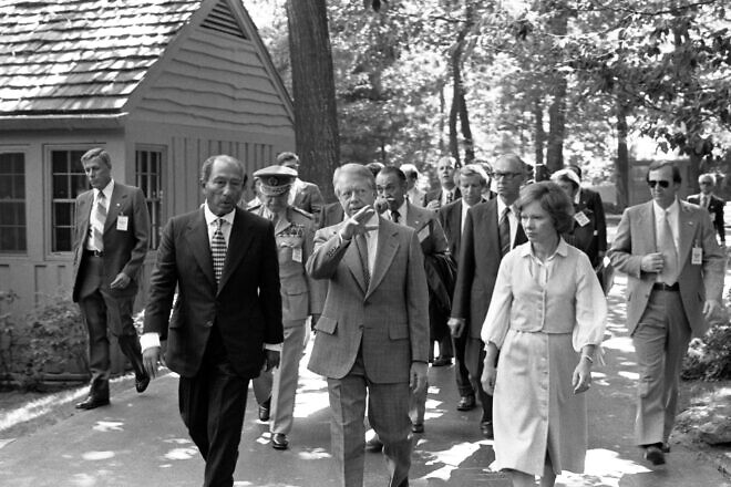 U.S. President Jimmy Carter, his wife Rosalynn Carter and Egyptian President Anwar Sadat walk at Camp David, Md., on Sept. 5, 1978. Credit: Jimmy Carter Library.