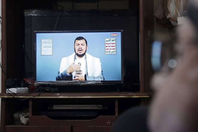 A Yemeni man watches Houthi leader Abdul Malek al-Houthi's televised address on the ceasefire in Gaza, at his home in Sanaa, on Jan. 16, 2025. Photo by Mohammed Hamoud/Getty Images.