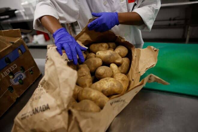 Volunteers prepare potatoes at Daily Bread Food Bank in Toronto on April 18, 2023. Photo by Cole Burston/AFP via Getty Images.