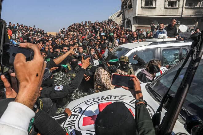 Hamas and Palestinian Islamic Jihad terrorists, as well as thousands of additional Gazans, in Khan Yunis in the Gaza Strip, where Israeli hostages Arbel Yehud and Gadi Mozes, along with five Thai captives, were released to the Red Cross on Jan. 30, 2025. Photo by Abed Rahim Khaatib/Flash90.