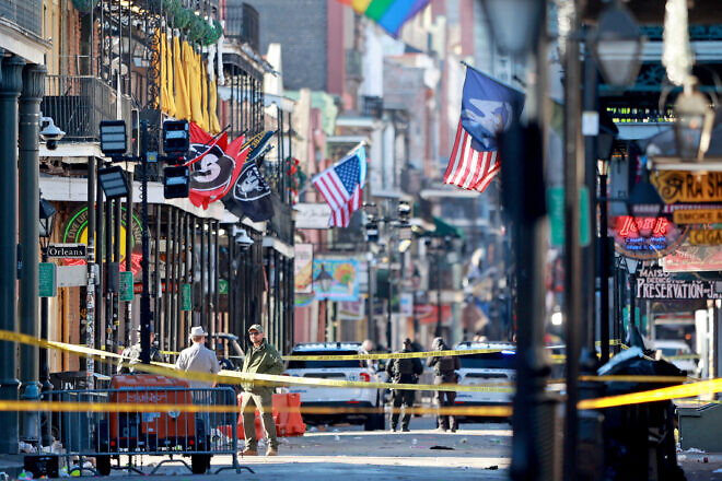 Law enforcement officers work the scene on Bourbon Street in New Orleans after 15 people were killed when a man drove into the crowd early on New Year's Day, Jan. 1, 2025. Photo by Michael DeMocker/Getty Images.