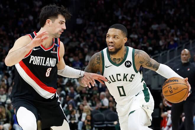 Damian Lillard of the Milwaukee Bucks drives to the basket on Deni Avdija of the Portland Trail Blazers during the second half of the game at Fiserv Forum in Milwaukee, Wis., on Jan. 4, 2025. Photo by John Fisher/Getty Images.