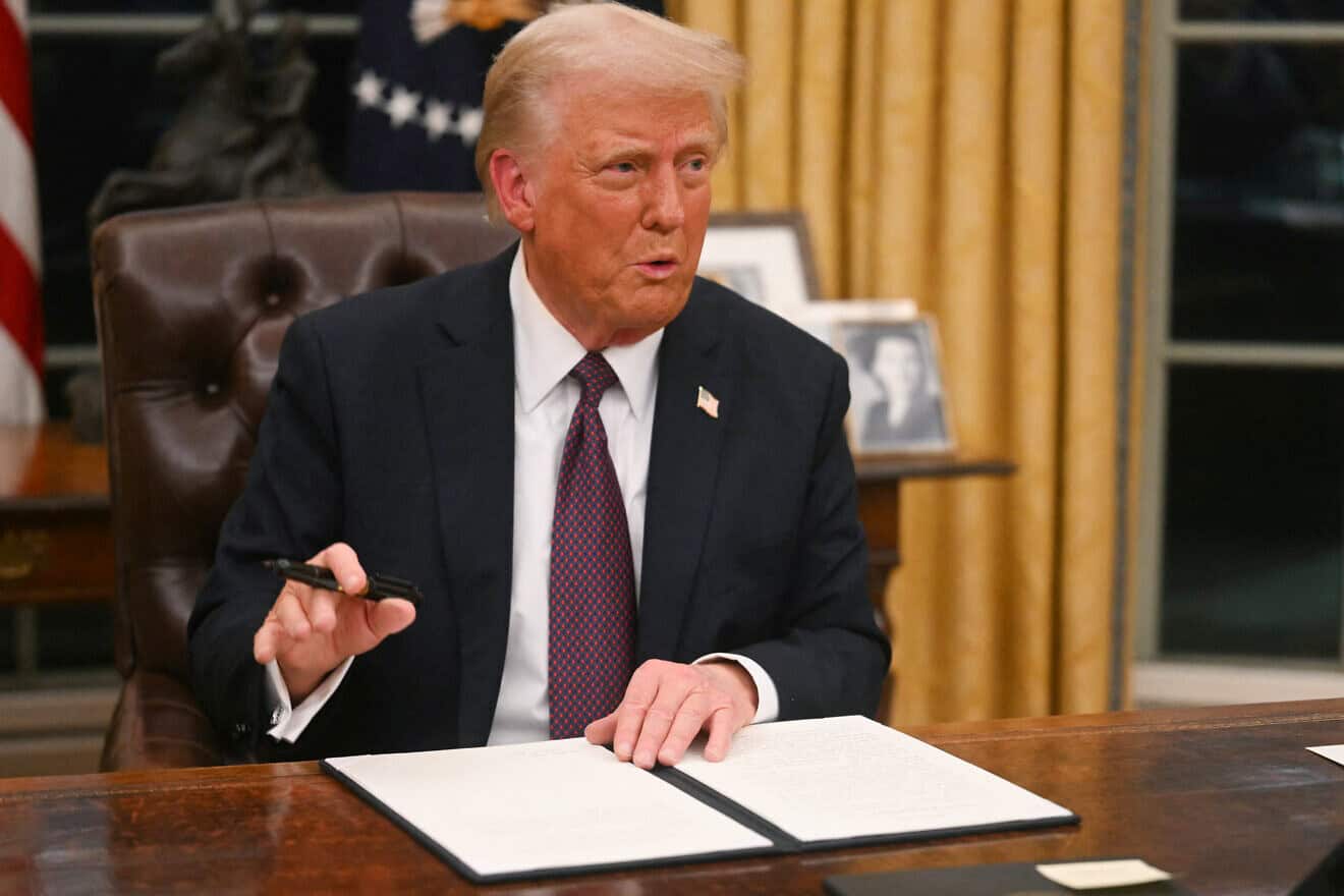 U.S. President Donald Trump signs an executive order in the Oval Office of the White House in Washington, D.C., Jan. 20, 2025. Photo by Jim Watson/POOL/AFP via Getty Images.