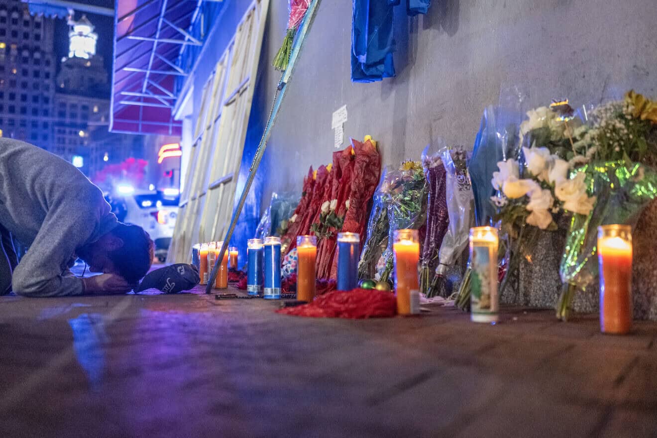 A man reacts to a memorial on Bourbon Street in New Orleans for the people killed in a car-ramming attack on New Year's Day after it reopened to the public, on Jan. 2, 2025. Photo by Andrew Caballero-Reynolds/AFP via Getty Images.