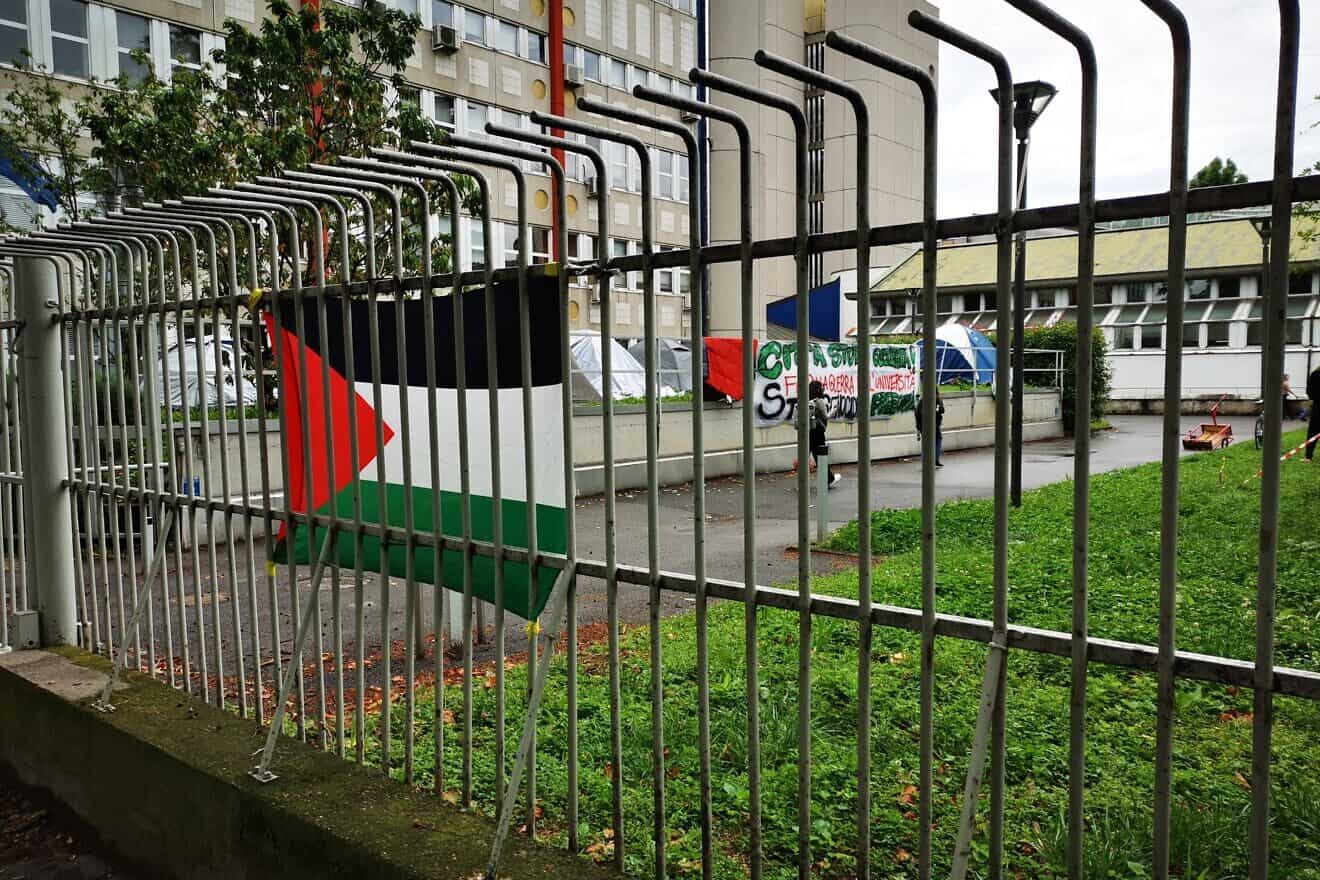 Pro-Palestinian flag and signs at the University of Milan. Credit: Saggittarius A via Wikimedia Commons.