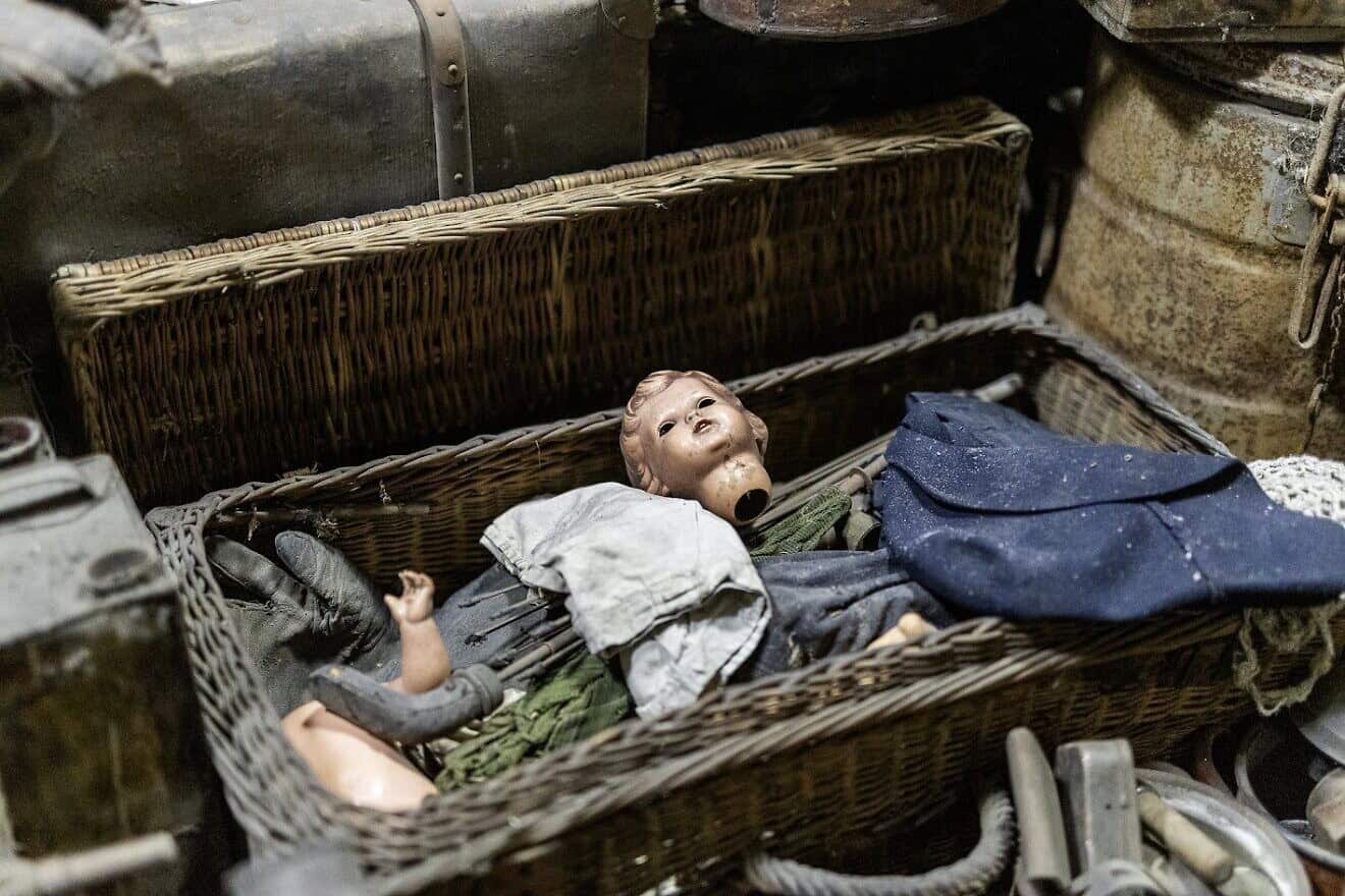 A doll's head lies inside one of the boxes storing a cache of items from the Auschwitz former death camp in Poland, donated in January 2025. Photo courtesy of Ambassador Yacov Livne/the Foundation of Memory Sites Near Auschwitz-Birkenau.