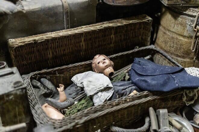 A doll's head lies inside one of the boxes storing a cache of items from the Auschwitz former death camp in Poland, donated in January 2025. Photo courtesy of Ambassador Yacov Livne/the Foundation of Memory Sites Near Auschwitz-Birkenau.