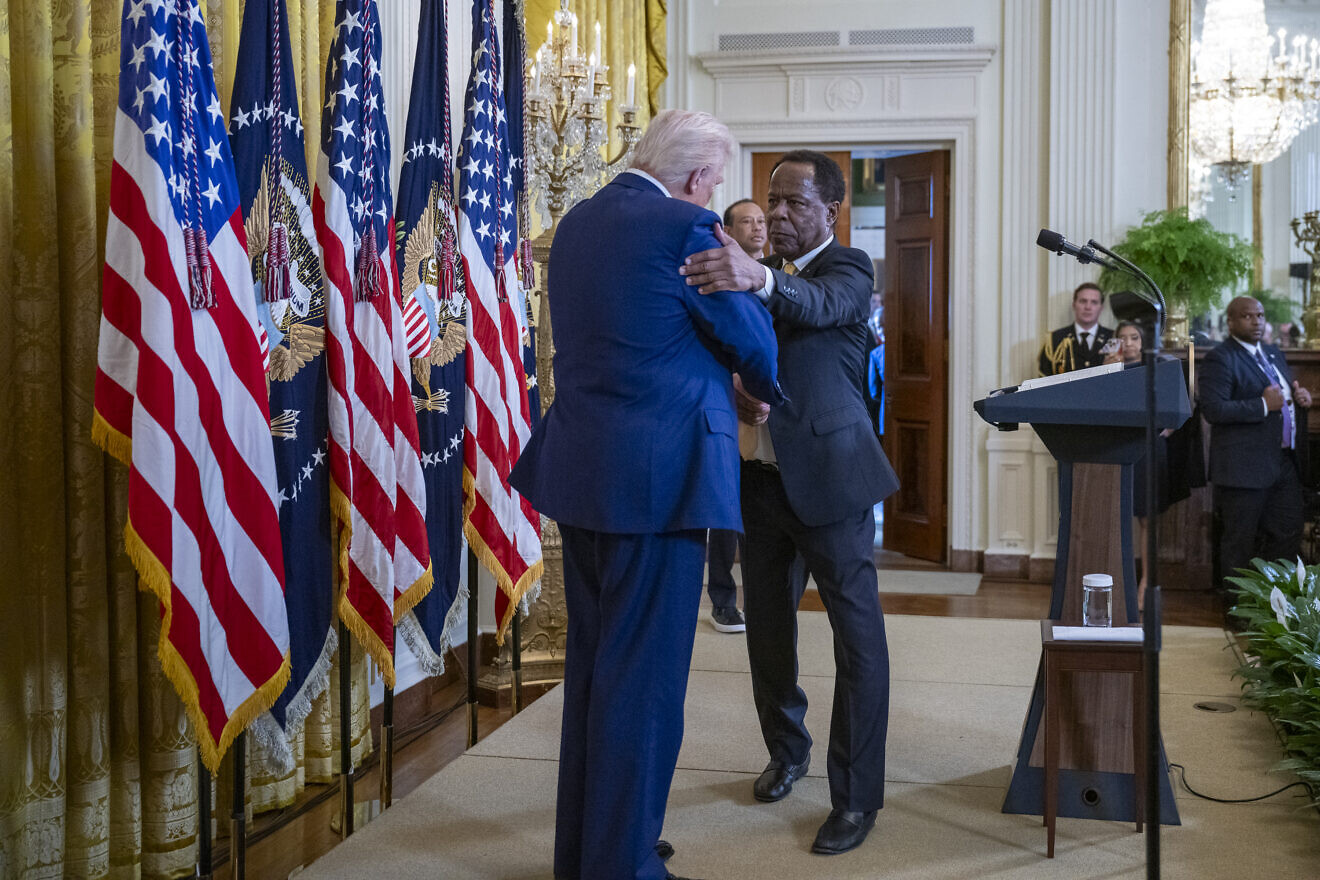 Leo Terrell, senior counsel to the assistant U.S. attorney general for civil rights, shakes U.S. President Donald Trump's hand at a reception honoring Black History Month in the East Room of the White House, Feb. 20, 2025. Credit: Molly Riley/White House.