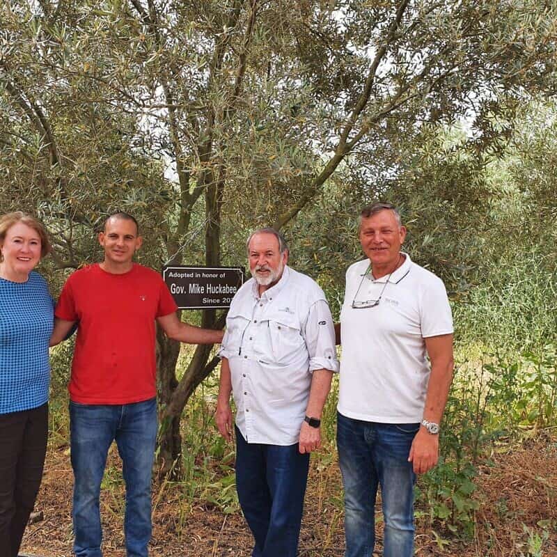 Former Arkansas Gov. Mike Huckabee (third from left) and his wife Janet with olive-grove farmer Gal Ashush (second from left) and My Tree in Israel founder Kobi Assaf in 2022. Credit: Courtesy/My Tree in Israel Archive Photo.