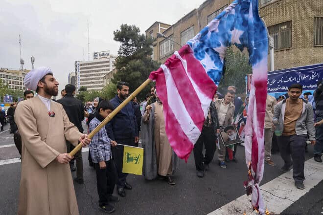 A man holds a burning American flag during a rally outside the former U.S. embassy in Tehran as Iranians mark the 45th anniversary of the start of the 1979 Iran hostage crisis, Nov. 3, 2024. Photo by ATTA KENARE/AFP via Getty Images.