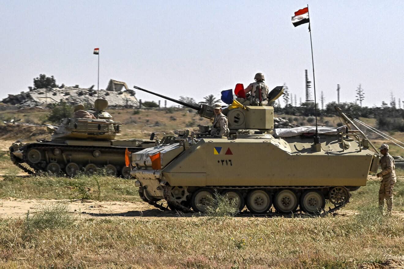 An Egyptian army M60 main battle tank and an infantry fighting vehicle (IFV) near the Egyptian side of the Rafah border crossing with the Gaza Strip on March 23, 2024. Photo by Khaled Desouki/AFP via Getty Images.