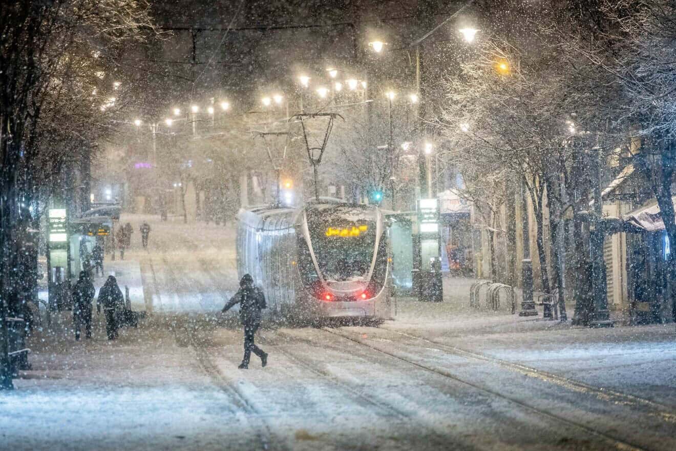 Snow falls on Jaffa Street in downtown Jerusalem as a heavy storm hits nationwide, Jan. 26, 2022. Photo by Yonatan Sindel/Flash90.