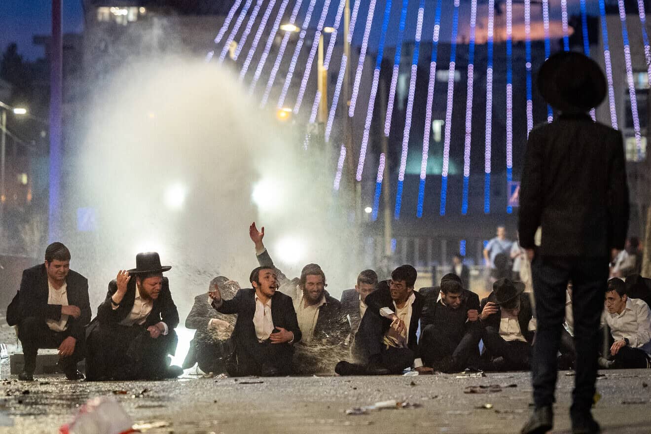Haredi Jews protest and clash with police during a protest against the drafting of Haredi Jews to the Israeli army, outside a conference on the issue in Jerusalem on Jan. 28, 2025. Photo by Chaim Goldberg/Flash90.